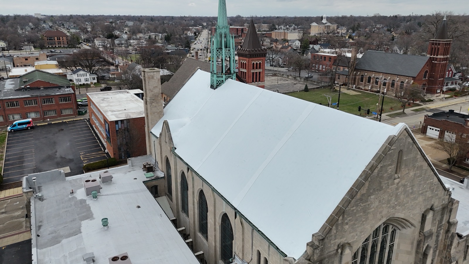 The same church sealed under a continuous white Elastowrap roof membrane