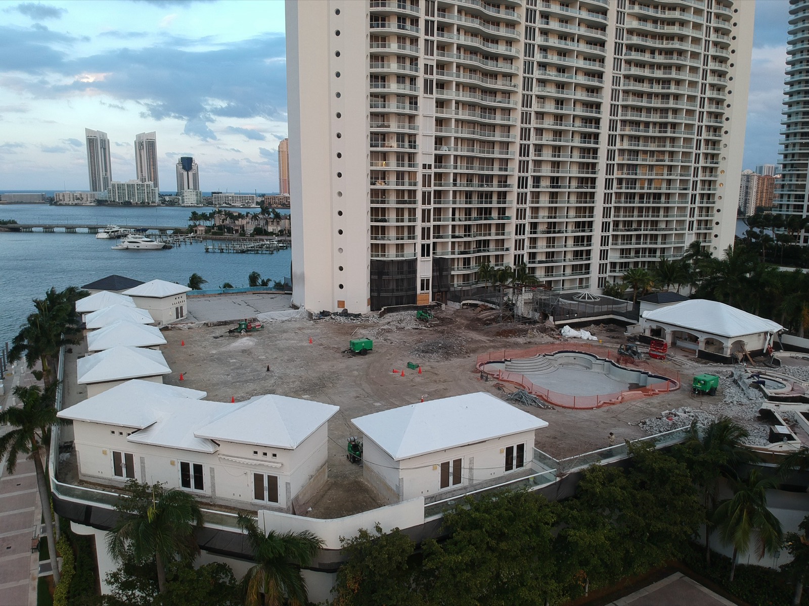Coastal condominium high-rise with stretch wrapped roofs after a hurricane