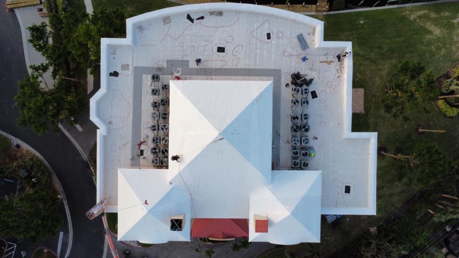 Commercial complex sealed under a large white Elastowrap roof, aerial view