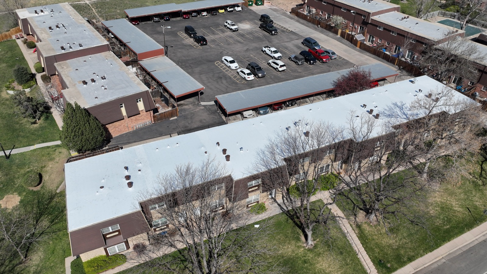 Commercial plaza with a white stretch wrapped roof, drone view