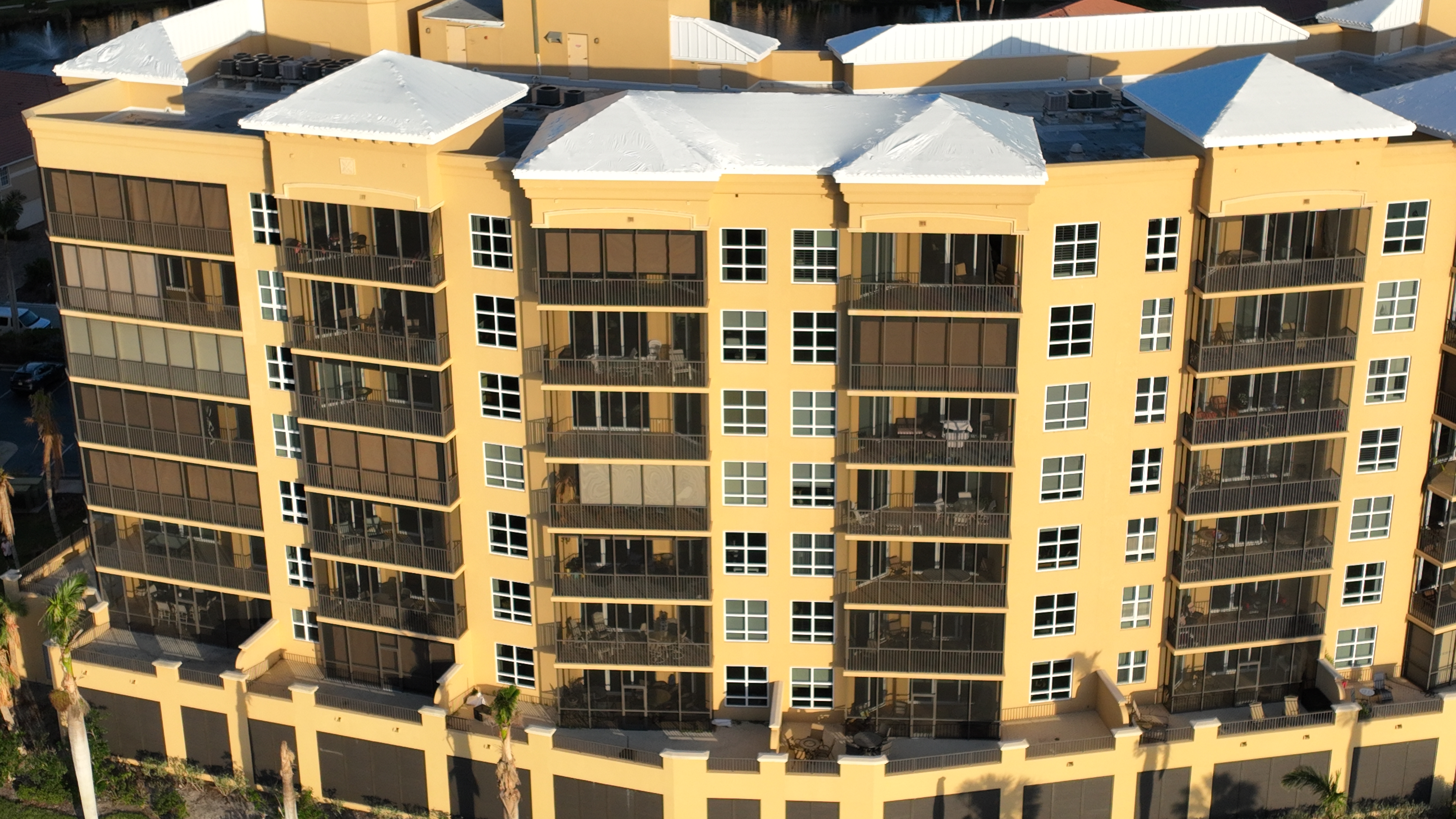 Multi-story condo tower with white Elastowrap sealed rooftop sections