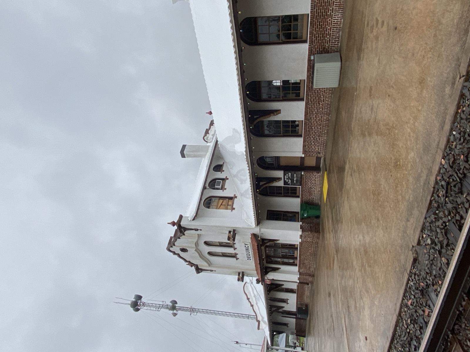 Historic train depot with a white stretch wrapped roof
