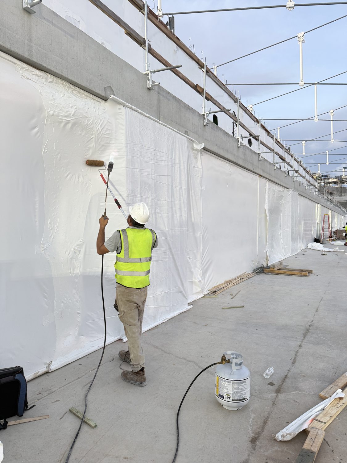 Crew sealing a Titanium Tarps perimeter enclosure